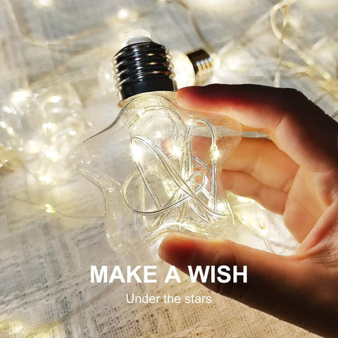 Hand holding star-shaped LED light from Star Curtain Lights With Wishing Ball LED Fairy String Lights USB Powered Remote Control 8 Modes Warm White Cozy Vibe Ambient Lighting For Backdrops Bedroom Parties Weddings Christmas Decor.