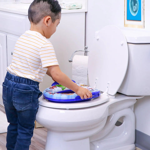 Child using Ultra Comfy Toddler Potty Training Seat With Rock Solid Side Handles And Dead Simple Rinse Off Design Made In Usa on toilet.