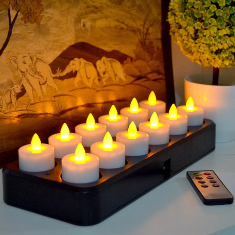 Rechargeable LED Tealight Candles With Timer Remote Flameless Amber Yellow Set Of 12 shown on inductive charging base