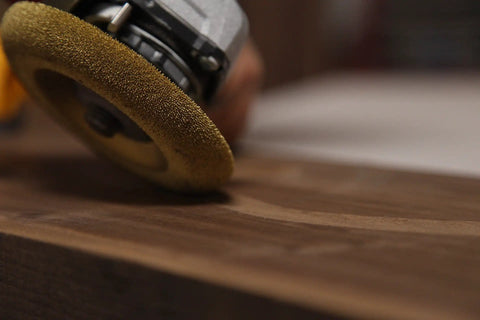 Close-up of Fine Shaping Disc for Woodworking, 4-1/2 Inch Diameter, 7/8 Inch Bore, Angle Grinder Attachment in use on wood surface