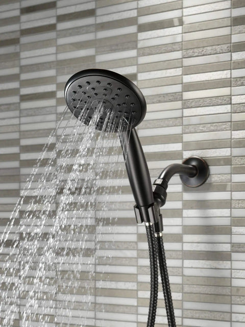 Porter 3 Setting Hand Shower Oil Bronze Finish Touch Clean Sprayer No Sweat Install Spot Shield Tech in use with water flowing.