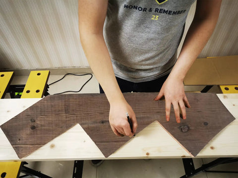 Person using DIY Friendly Stair Stringer Cutting Layout Tool Four Step Guide To Measure Calculate Mark And Cut on lumber