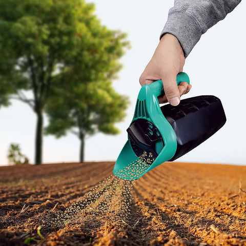 Hand holding All Season Handy Seed Spreader For Lawn Care Pro Grade Adjustable Grass Seed And Fertilizer Spreader over soil.
