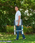 Person carrying Extendable Aluminum Telescoping Ladder With One Button Retraction 12.5 Ft Portable Folding Ladder in garden
