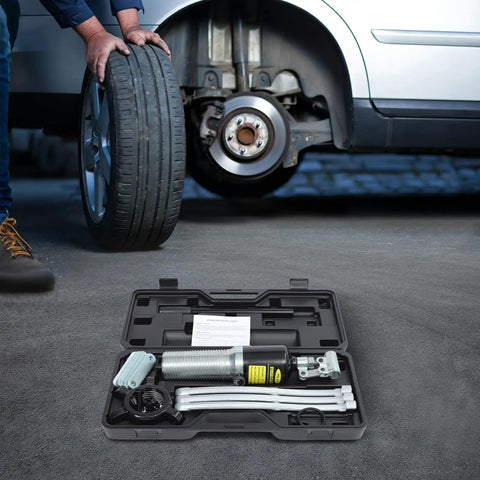 Heavy Duty 20 Ton Hydraulic Bearing Puller Kit For Mechanics Features Two Or Three Jaw Remover Built From Rust Resistant Steel Integrated Pump Hose System Designed To Remove Stuck Parts Fast Without Breaking Anything For Real Mechanics And Shop Work, open case beside car wheel hub