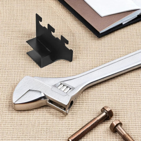 Black Stainless Steel Shelf Brackets 2 Pack With Square Pipe Design next to wrench and bolts on table