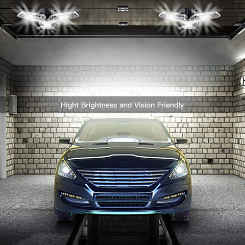 Ultra Bright LED Garage Light Deformable Ceiling Panel 9000 Lumens 82W CRI 80 in a garage illuminating a blue car