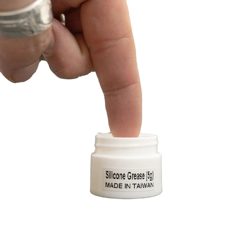 Finger dipping into Silicone Grease For O-Rings And Seals, 5G Multi Purpose Lubricant For Scuba Gear, Extends Rubber Lifespan, Reduces Cracking And Wear, Ideal O-Ring Maintenance And Seal Protection jar