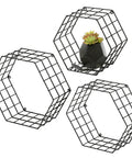 Matte Black Hexagonal Wire Mesh Floating Shelves Set Of 3 Wall Mounted Display Rack For Bedroom Or Office with a small plant.