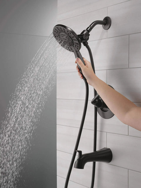 Slick Matte Black Bathtub Shower Faucet Set With 2-In-1 Dual Shower Head And Handheld Spray Combo in use, showcasing sleek design and water flow.