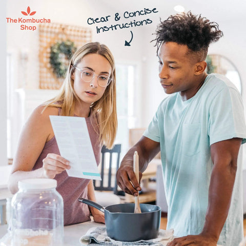 Couple reviewing instructions for Organic 1 Gallon Kombucha Starter Kit With SCOBY Fermentation Jar Tea And Sugar Bottling Essentials