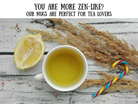 Top view of a lemon slice, tea in a white mug, candy cane, and dried grass on a wooden surface with tea lover text above.