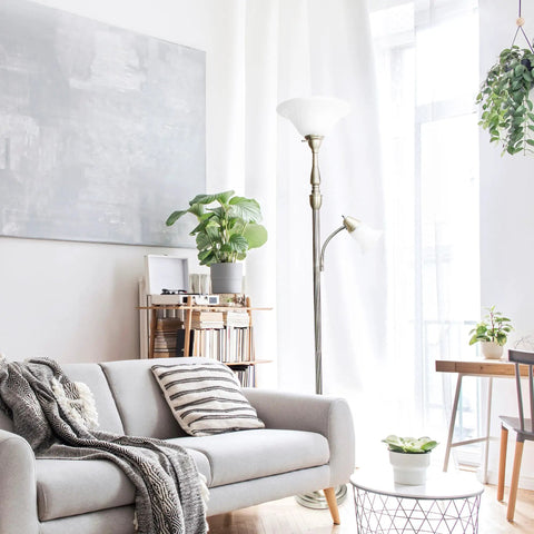 Two Light Mother Daughter Floor Lamp With White Marble Glass Shades In Brushed Nickel Finish next to a grey sofa in bright room