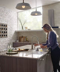 Woman using Spot Resist Stainless Modern Deck Mounted Kitchen Soap Dispenser With Above The Sink Refillable Bottle