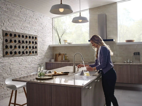 Woman using Spot Resist Stainless Modern Deck Mounted Kitchen Soap Dispenser With Above The Sink Refillable Bottle