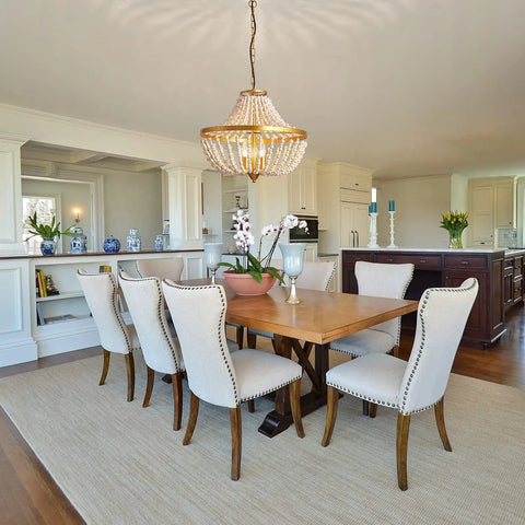 Three Light Boho Wood Beaded Gold Chandelier for Rustic Farmhouse Style Pendant Light Fixture above dining table in elegant room.