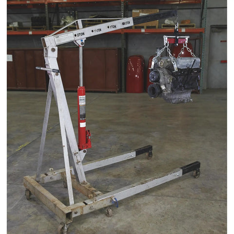 Heavy Duty 8 Ton Long Ram Hydraulic Floor Jack With Rapid Double Piston Pump for lifting an engine on a shop crane.