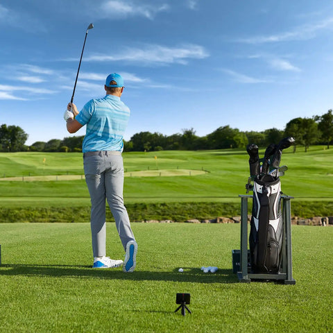 Golfer using Portable Golf Launch Monitor and Simulator Bundle for home outdoor or indoor practice with real shot metrics