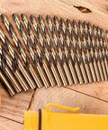29 Piece Drill Bit Set With 135 Degree Split Point, Jobber Length, Orange And Gold Finish, Sizes 1/16 To 1/2 Inch, laid on wood surface
