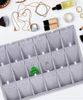 Super Smooth Large 18 Compartment Velvet Jewelry Storage Tray With Handy Necklace And Watch Display Pad Totally Organized For Craft Sessions And Stylish Desk Vibes with rings and a green decorative piece.