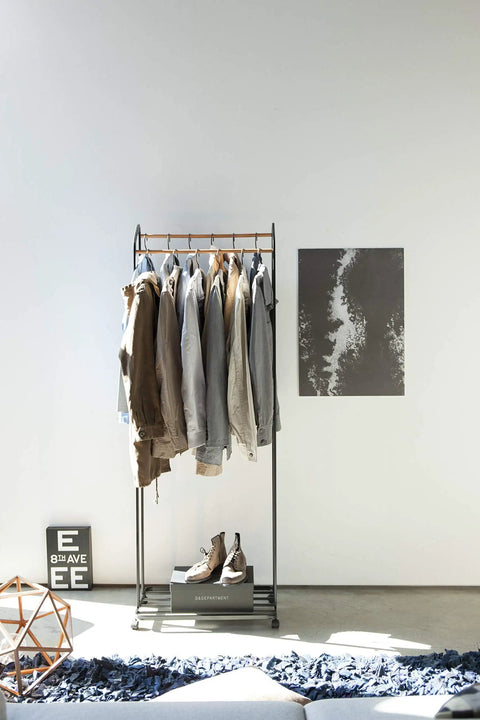 Kickass Rolling Wardrobe Rack With Staggered Wooden Bars And Roomy Bottom Shelf Built Tough With Steel Frames Delivers The Ultimate Flex For Portable Closet Setup Anywhere Glides On Smooth Casters with clothing hanging.