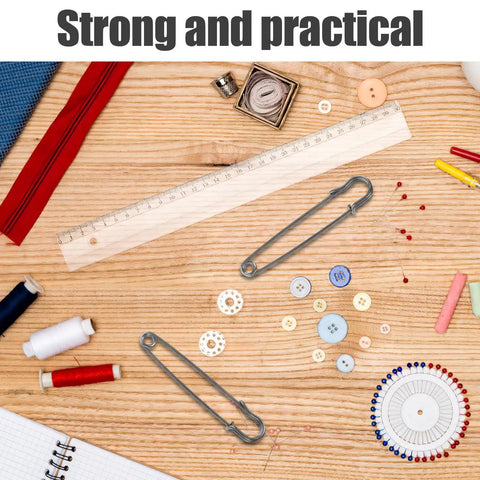 Bold 50pcs Heavy Duty Iron Safety Pins For Sweater Clips and Jacket Closures Plus Retro Brooches For DIY Crafters on a wooden table.