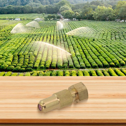 Image of High Pressure Adjustable Copper Spray Nozzle For Agricultural Sprayers Farm Ready Irrigation And Crop Protection One Point Five Hole Easy Turn Control Pro Grade Watering Solution in front of a lush green farm field with active irrigation.