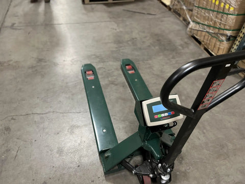Industrial Grade Heavy Duty 2500 Lb Digital Pallet Jack Scale With Slick Low Profile Build And Hella Solid Steel Frame for easy cargo weighing in a warehouse.