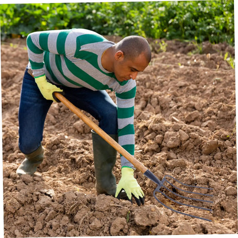 Person using Multi Functional Manure Fork For Lawn Care And Farm Use A Rugged Heavy Duty Pitch Fork For Clearing Debris And Manure
