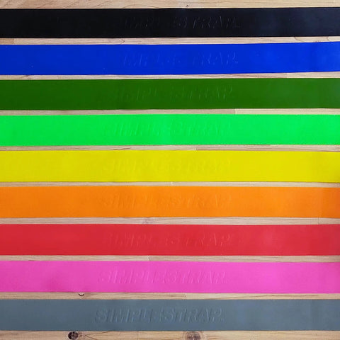 Heavy Duty Yellow Tie Down Strap 1.6 Inch Wide By 20 Feet Long with various colored straps on wood background.