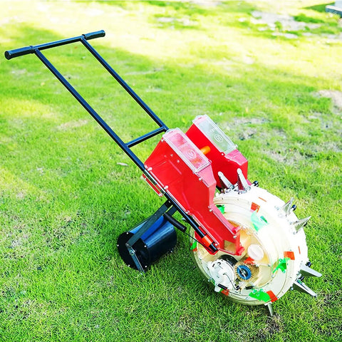 Hand Push Garden Seeder Spreader with dual buckets for seeds and fertilizer on grass, durable manual planter and applicator tool.