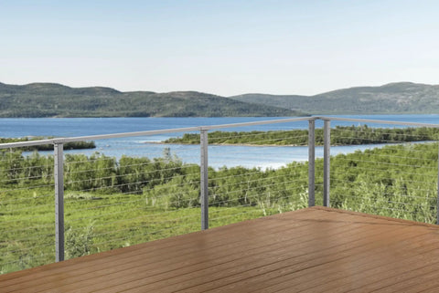 Complete 30 Ft Cable Railing Kit For Decks And Patios With Marine Grade Stainless Steel Wire installed on a scenic deck overlooking water.