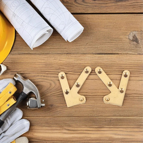 Brass Invisible Door Hinges Set Down Pivot Concealed Design on wood surface with tools and gloves nearby