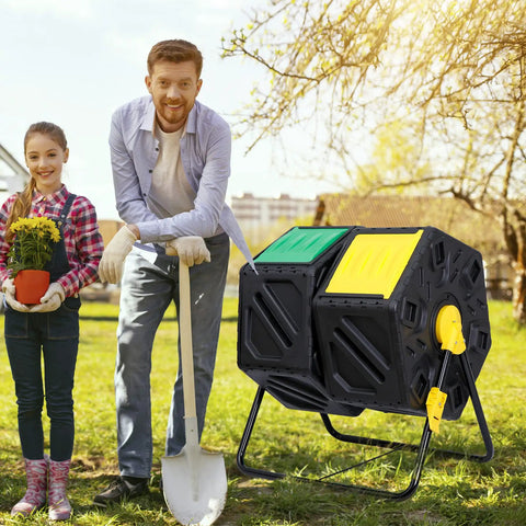 Outdoor 37 Gallon Dual Chamber Compost Bin With Tumbling Drum And Two Sliding Doors next to man with shovel and girl with plant in garden.