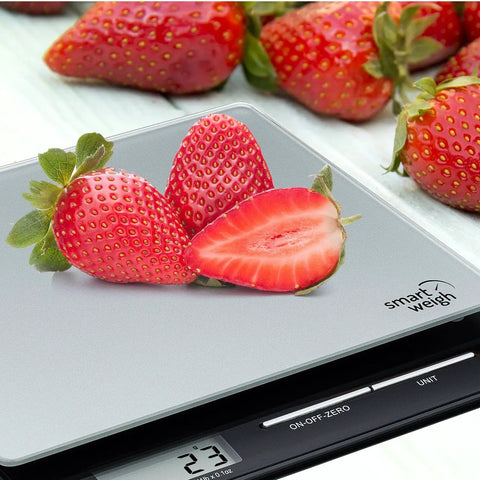 Get Your Hands on This Highly Accurate Digital Postal Scale Featuring a Durable Tempered Glass Platform with strawberries on top.
