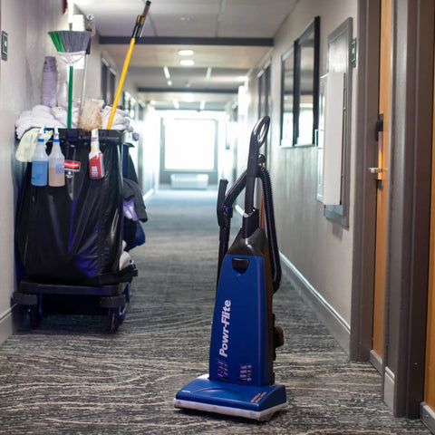 Powr-Flite Borelli Dual Pro Upright Vacuum With HEPA Filtration for Heavy Duty Commercial Use on carpet in hotel hallway.