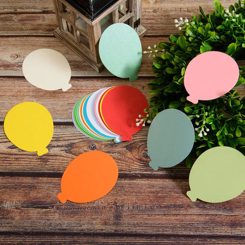 Assorted 360 Die Cut Paper Balloon Cutouts 3.9 Inch for Classroom Bulletin Boards DIY Crafts Party Decor on wooden table