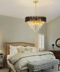 Five Light LED Teardrop Crystal Pendant Chandelier In Gold Finish For Kitchen Island Foyer Hallway And Bedroom Modern Raindrop Ceiling Light With 4000K Neutral White Glow Lit above a bed with beige linens.