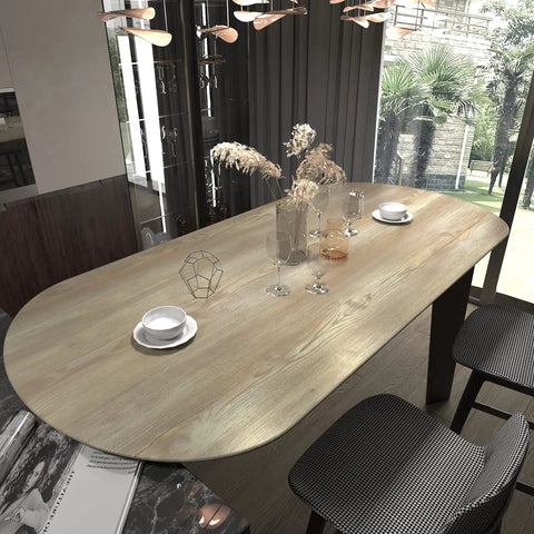 Oval dining table with faux wood grain contact paper, showcasing a vintage oak finish in dining room.