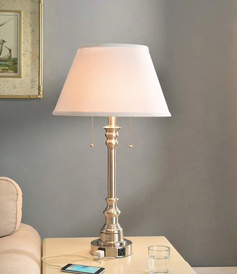 Spyglass Table Lamp With Dual Outlets In Brushed Steel Finish on a table, classic style, 30.5 inches tall, living room view