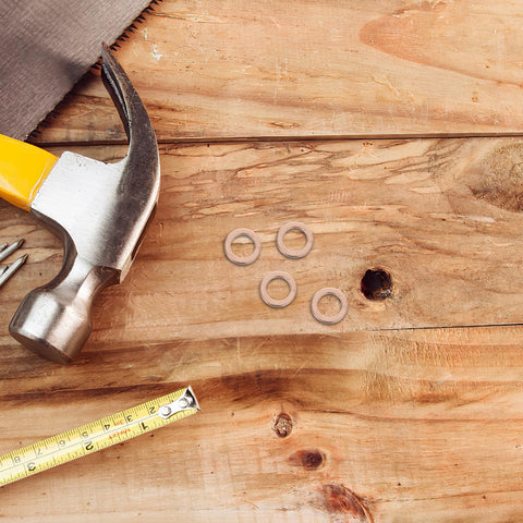 Copper Washer Kit 40 Pcs Set For Oil Drain Plugs And Hydraulic Seals with tools on wooden surface