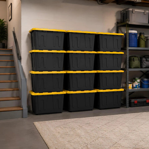 Tough As Nails Heavy Duty Storage Totes With Lids 27 Gallon stackable black bins arranged neatly in garage for organization.
