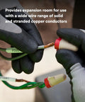 Hands connecting Solid As A Rock Tan And Red Wire Connectors For Twenty Two To Eight Gauge Cables with copper wire.