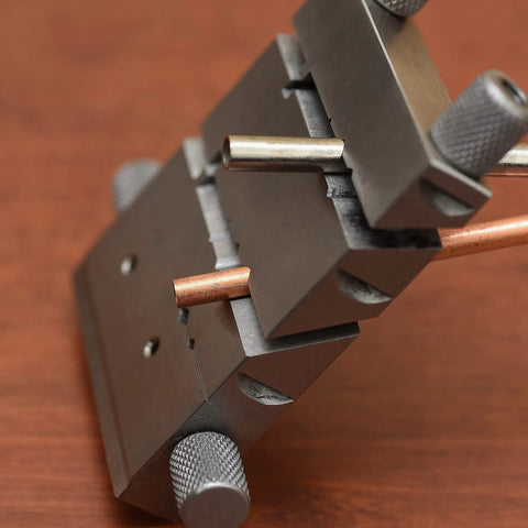 Swiss Style Miter Cutting Vise Jig Forged From Hardened Steel Measures Three Point Seven Five Inches with copper and steel rods.