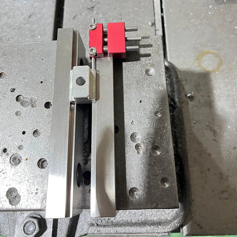 Top Shelf Six Inch Steel Double Step Milling Vise Jaws For Cnc Workbench Rigs with aluminum base and red locking bolts.