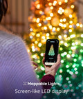 Person using app to control 105 Foot Smart String LED Lights with 400 RGB White LEDs on Christmas tree, WiFi and Bluetooth.