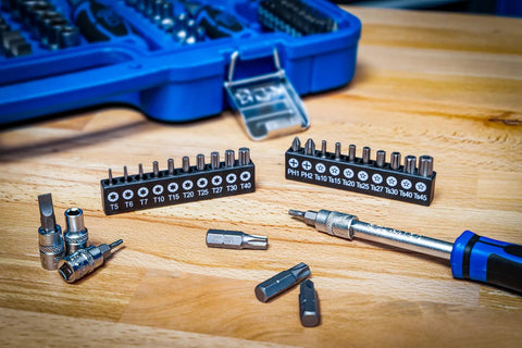 Master Grade 150 Piece Socket Set With Quarter Inch And Half Inch Drives Featuring Super Lock Sockets deep and short profiles on a wooden table.
