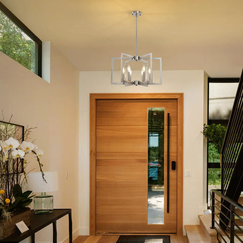 Top Tier Six Light Modern Metal Geometric Chandelier In Sleek Brushed Nickel hanging above a wooden front door in an entryway.