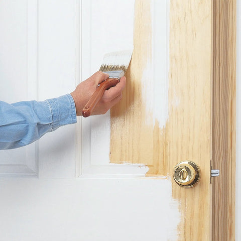 Hand applying Bullseye 1-2-3 Plus Primer Go-To Interior Exterior Oil Based Sealer on wooden door with paintbrush