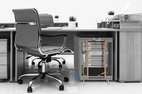 Solid Floor Standing Server Rack Cabinet With Secure Locking Doors For Heavy Network Gear And Router Hardware Straight Up Engineered For Reliable Storage In 12U And 18U Black Finish placed next to an office chair.